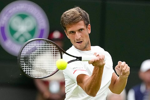 Vit Kopriva plays a return to Novak Djokovic